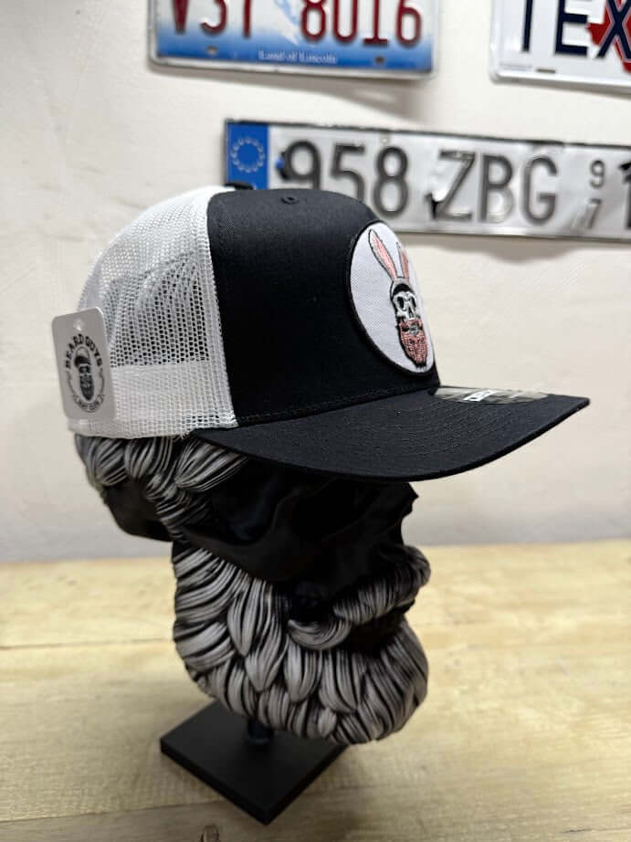Easter Bunny Beard Guy Trucker Hat showcasing a skull with beard and bunny ears on a black and white cap.