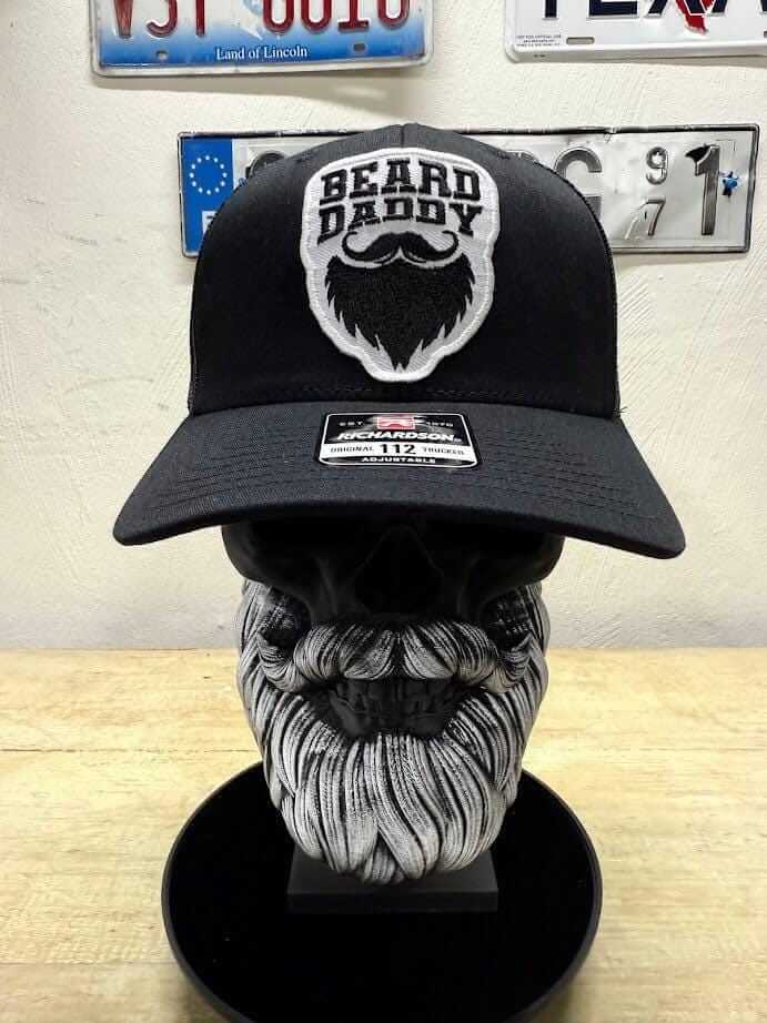 Beard Daddy Trucker Hat featuring bold 'Beard Daddy' patch on black Richardson 112 hat, displayed on a skull with a beard.