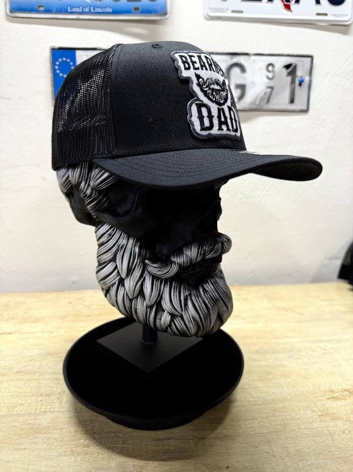 Beard Daddy trucker hat displayed on a stylish beard-themed head sculpture showcasing the embroidered design.